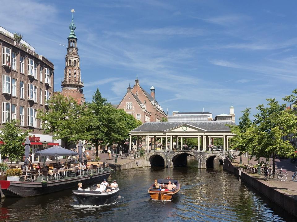 Leiden town hall and the Koornbrug bridge seen across the Nieuwe Rijn canal