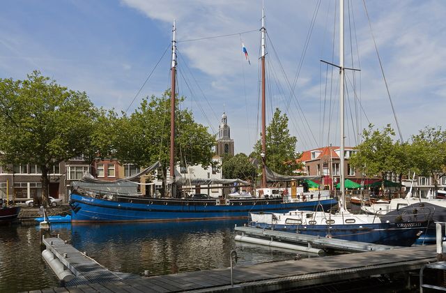 View over the harbour of Vlaardingen with the tower of the Grote Kerk in the background