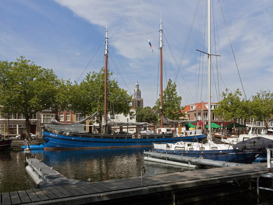 View over the harbour of Vlaardingen with the tower of the Grote Kerk in the background