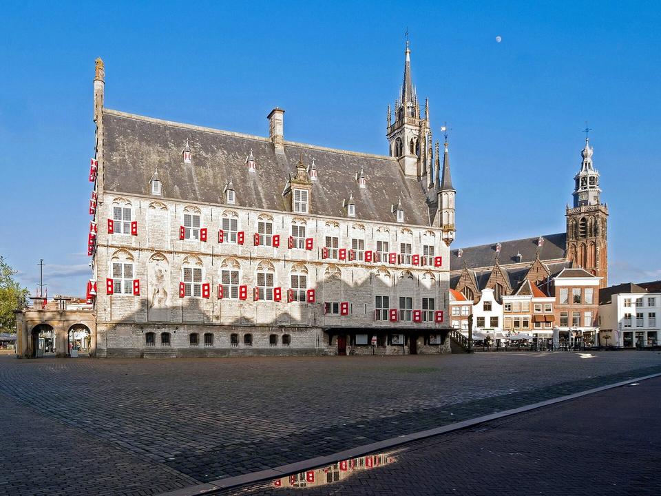 Gouda's Markt square with the medieval city hall and Sint-Janskerk tower on a clear day