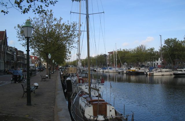 Historic ships moored in the Oude Haven of Vlaardingen with old quayside houses behind