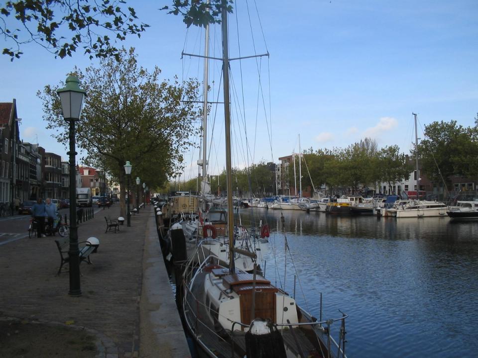 Historic ships moored in the Oude Haven of Vlaardingen with old quayside houses behind