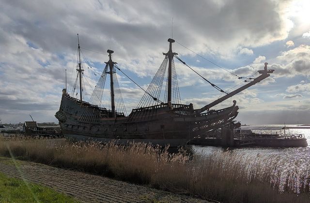 The Batavia museum ship moored in Bataviahaven, Lelystad, with the waterfront apartments of the harbour district behind it