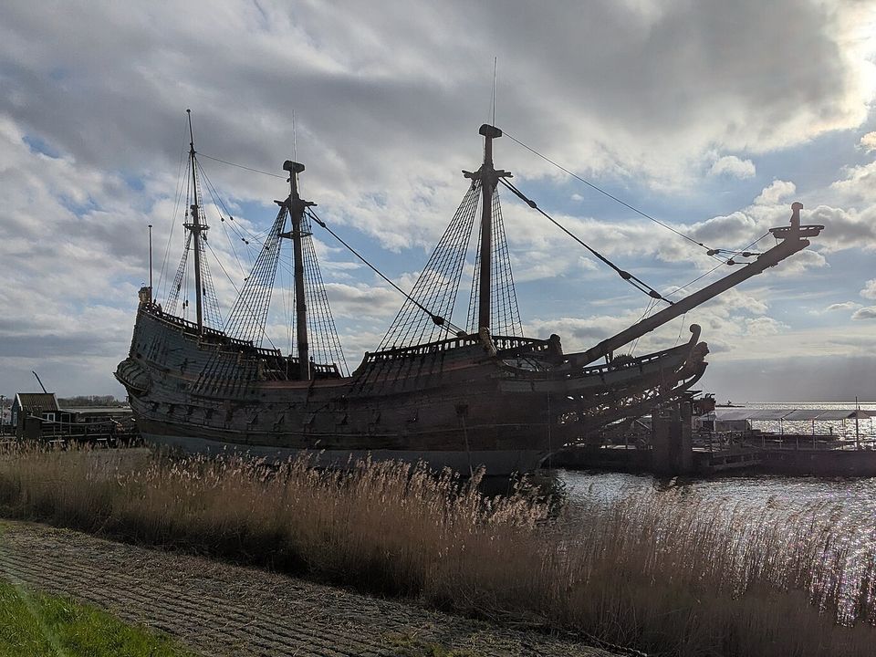 The Batavia museum ship moored in Bataviahaven, Lelystad, with the waterfront apartments of the harbour district behind it