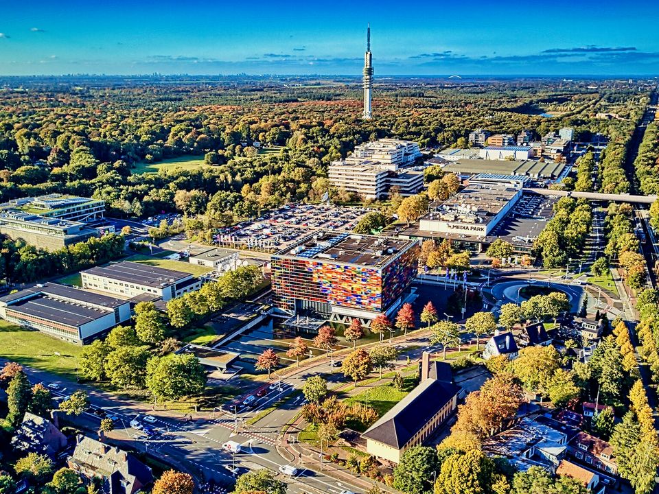 Aerial view of the Media Park broadcasting complex surrounded by trees in Hilversum