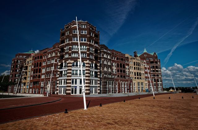 Bataviahaven harbour in Lelystad with moored boats and modern waterfront buildings along the Markermeer
