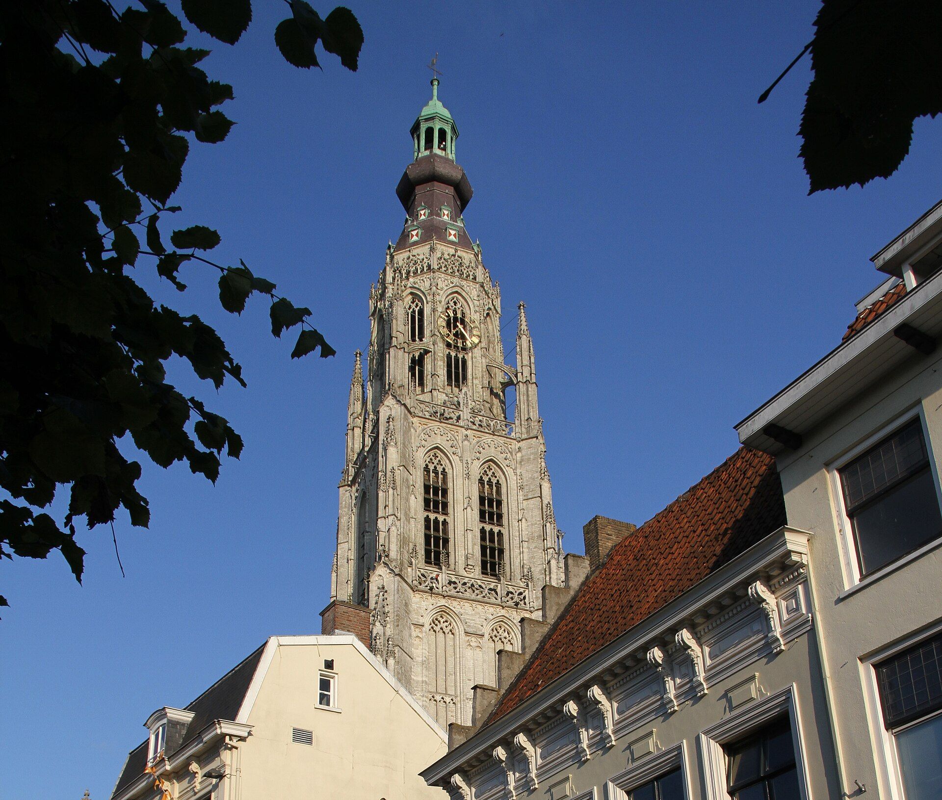 The Gothic tower of the Grote Kerk rising above rooftops in the historic centre of Breda