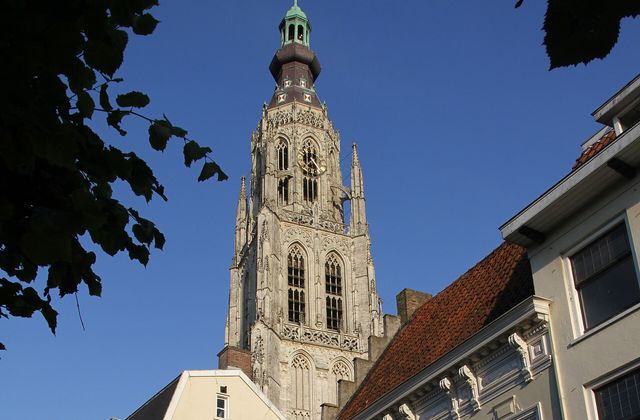 The Gothic tower of the Grote Kerk rising above rooftops in the historic centre of Breda