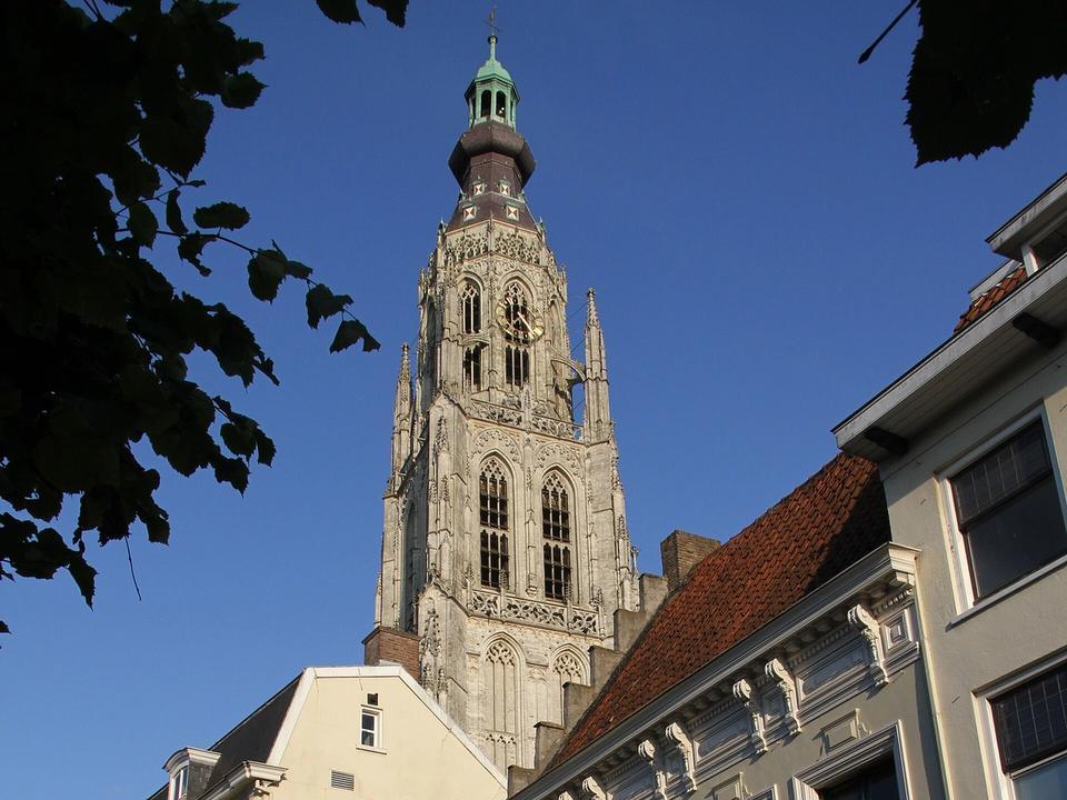 The Gothic tower of the Grote Kerk rising above rooftops in the historic centre of Breda