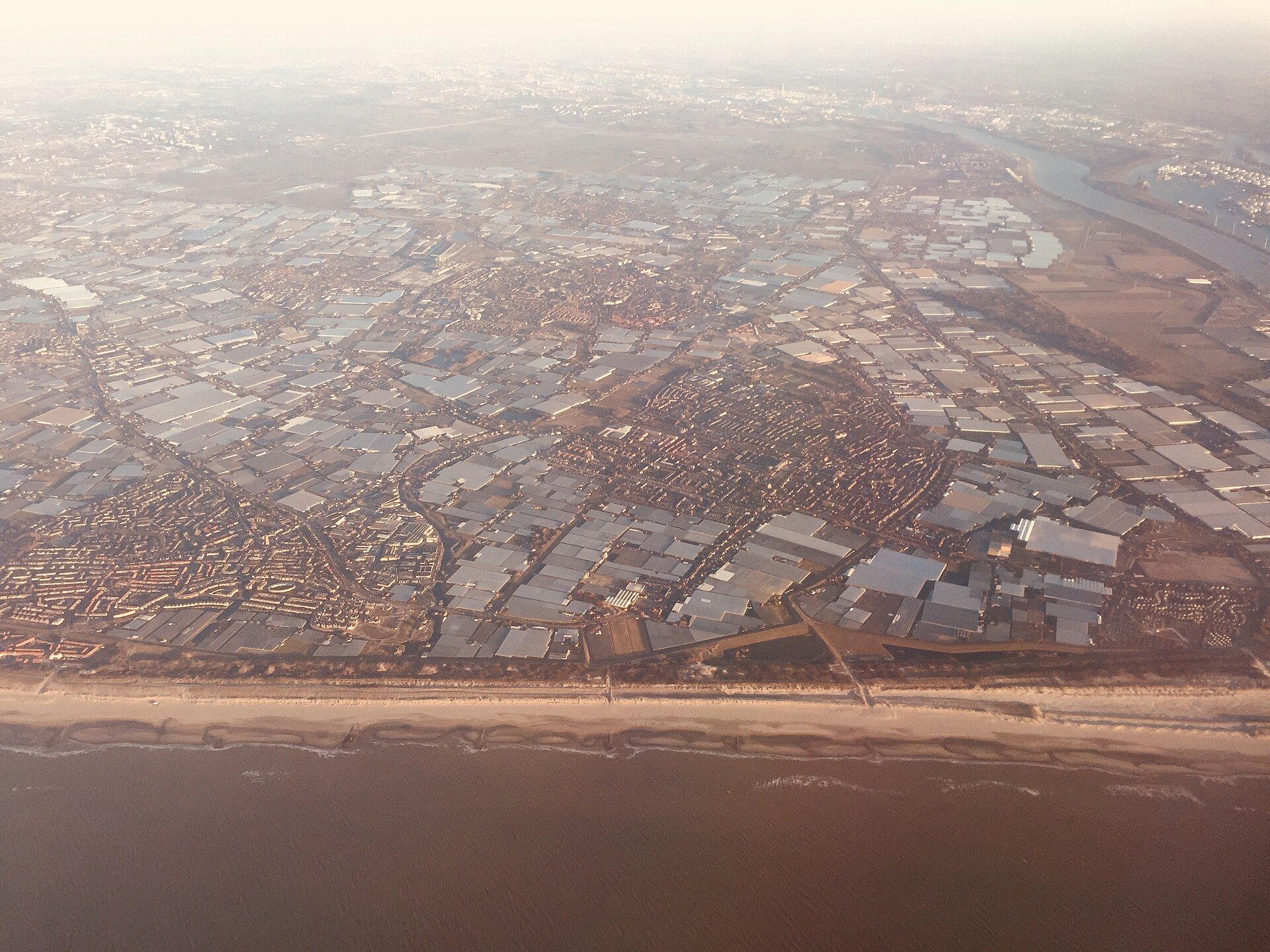 Aerial view of the glass greenhouses covering the Westland region in the Netherlands