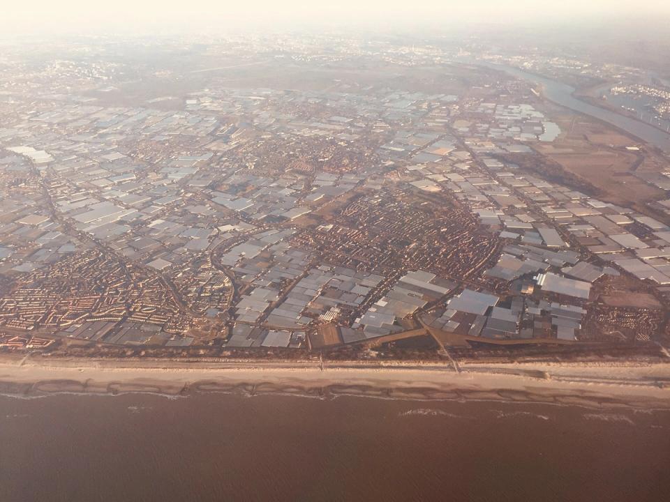 Aerial view of the glass greenhouses covering the Westland region in the Netherlands