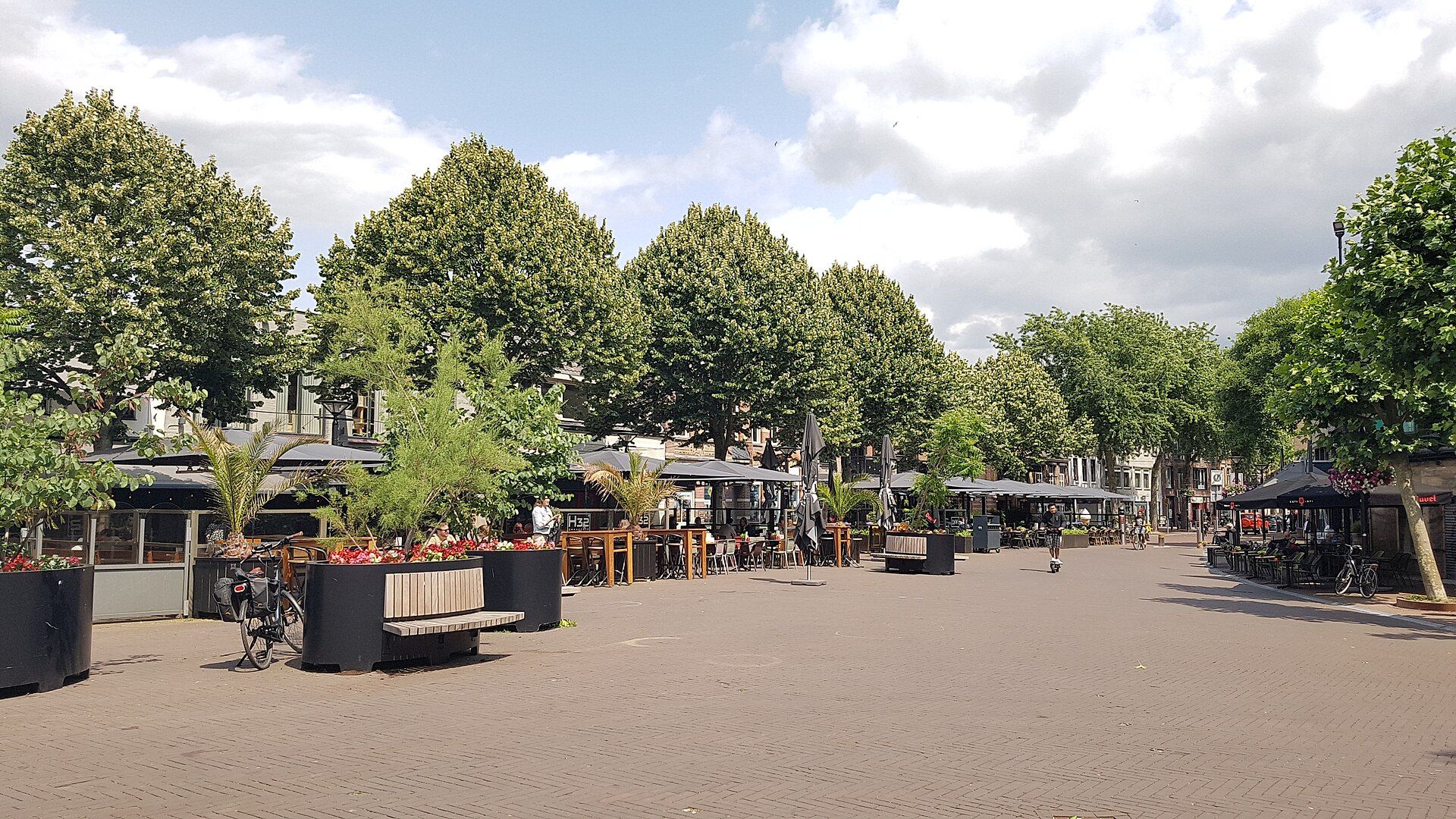 Cafe terraces on the Heuvel, the central square of Oss, on a summer day