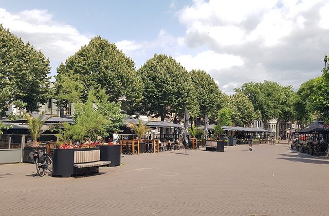Cafe terraces on the Heuvel, the central square of Oss, on a summer day