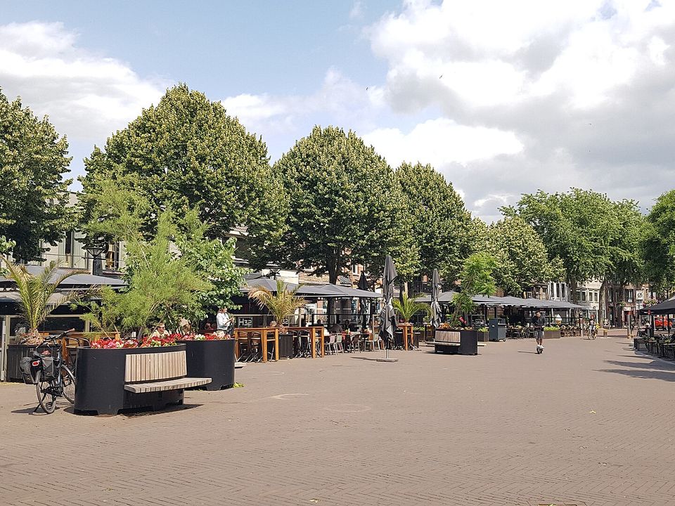 Cafe terraces on the Heuvel, the central square of Oss, on a summer day