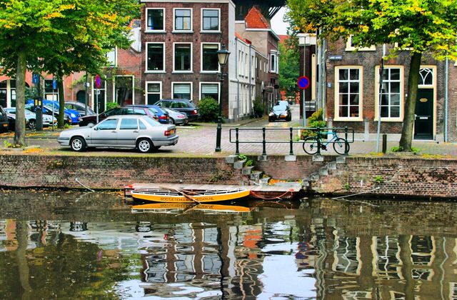 The historic windmill De Walvisch, one of Schiedam's giant mills, towering over a canal in the city centre
