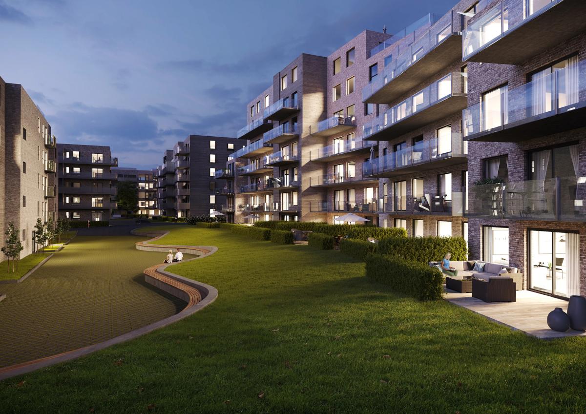 Visualisering som viser prosjektet på kveldstid. Lys fra leiligheter, bygg i ulike høyder og et organisk utformet landskap med sittebenk. 