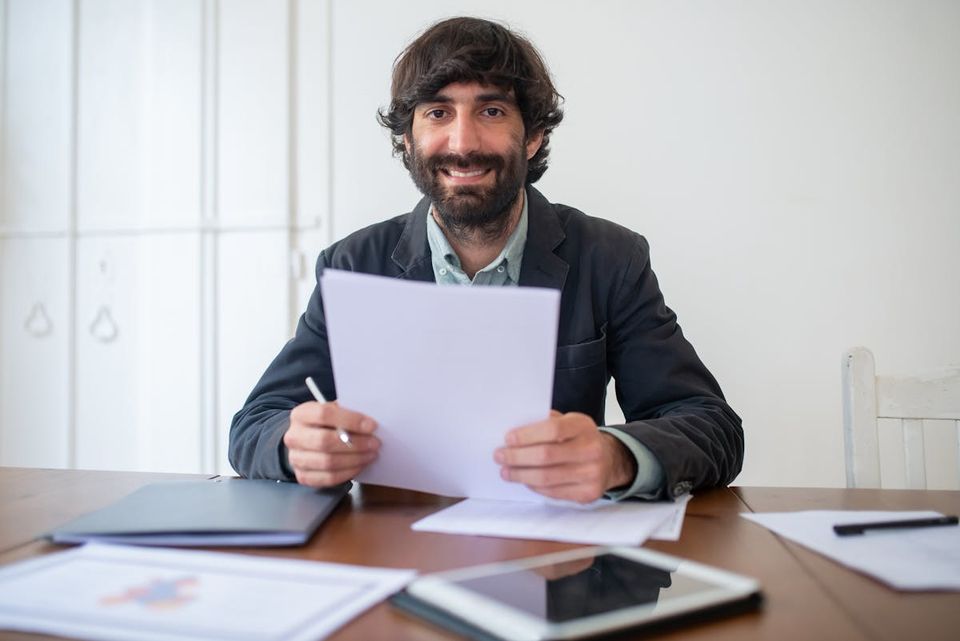 Real estate investor reviewing property records and exit documentation across portfolio