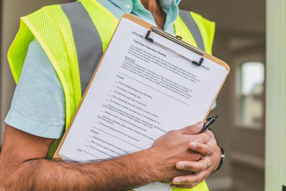 Close-up of a clipboard and pen used to inspect a home