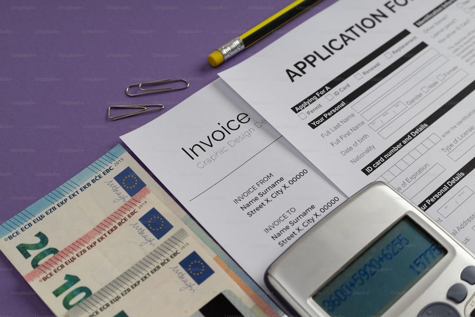 Building department permit office counter with renovation plans and permit application forms