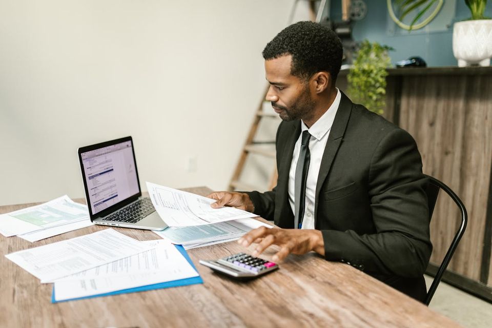 Real estate agent reviewing AI-powered listing tools on a laptop in a modern office