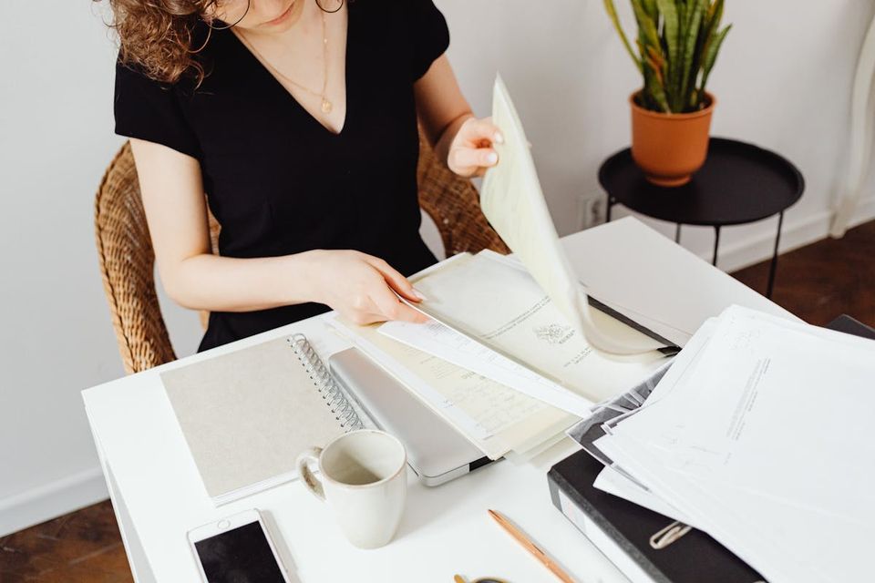 Homeowner digitally organizing property documents and receipts at a home office