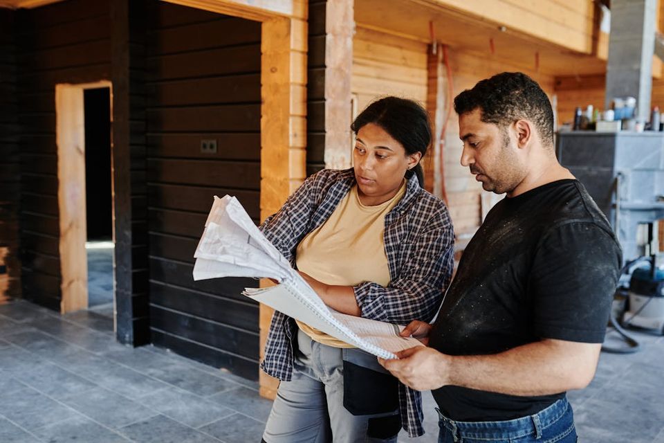 Contractor and homeowner reviewing completed renovation work together for final documentation