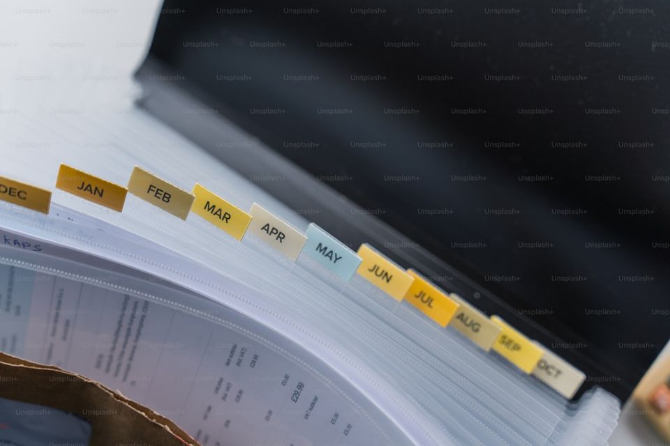 A property history report binder with tabbed sections for maintenance, permits, and warranties