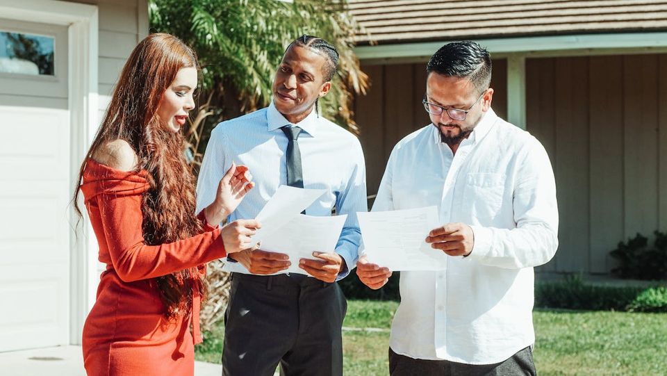 Homeowner holding a printed property record after closing