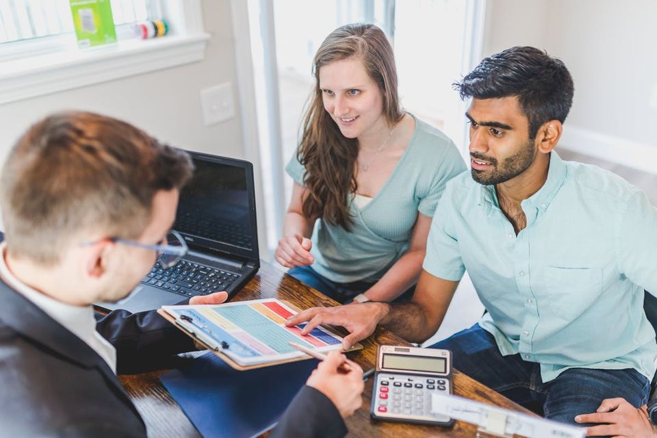 Seller reviewing a home inspection report with their real estate agent