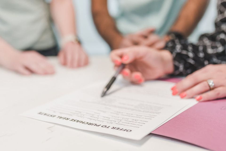 Seller property disclosure form on a desk with a pen ready to sign