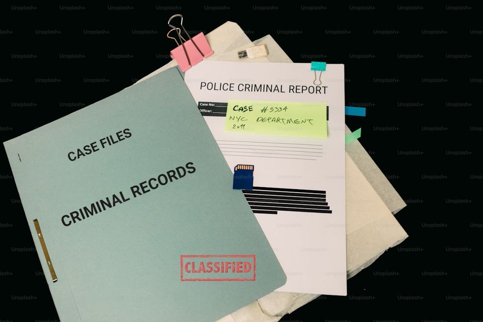 Insurance claim documentation organized in folders showing damage photos, estimates, and correspondence