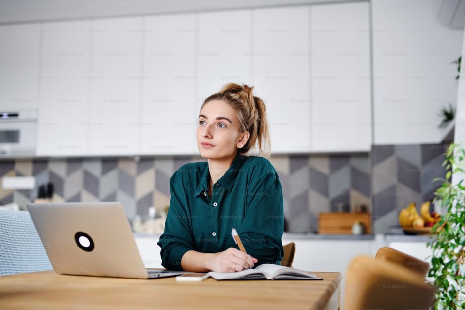 Homeowner reviewing property documentation report on a laptop at a kitchen table