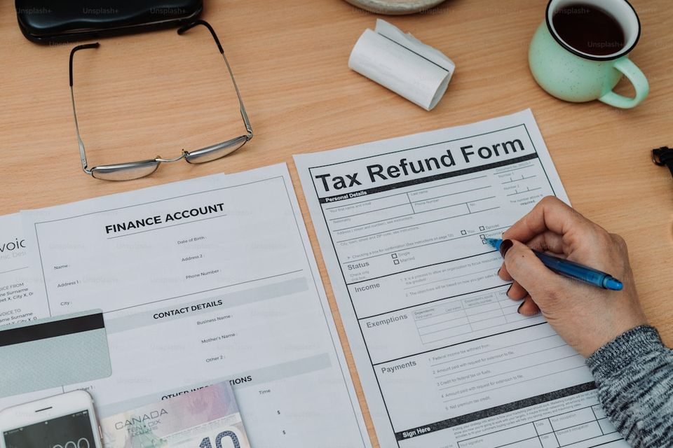 Homeowner gathering refinancing paperwork including tax returns and pay stubs
