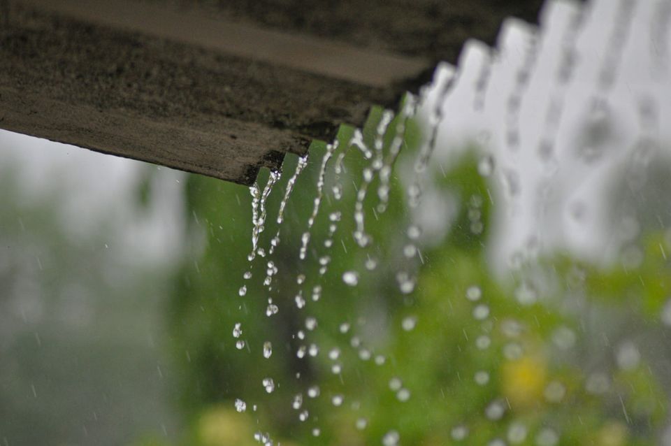 Before and after comparison showing clogged gutters with overflow versus clean gutters with proper drainage