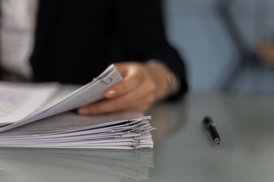 Checklist of essential home purchase and closing documents spread on a desk