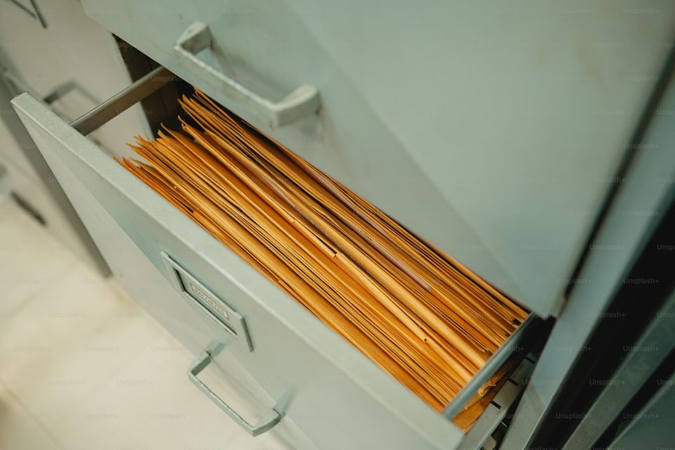 Organized filing system showing rental documents separated by property and unit