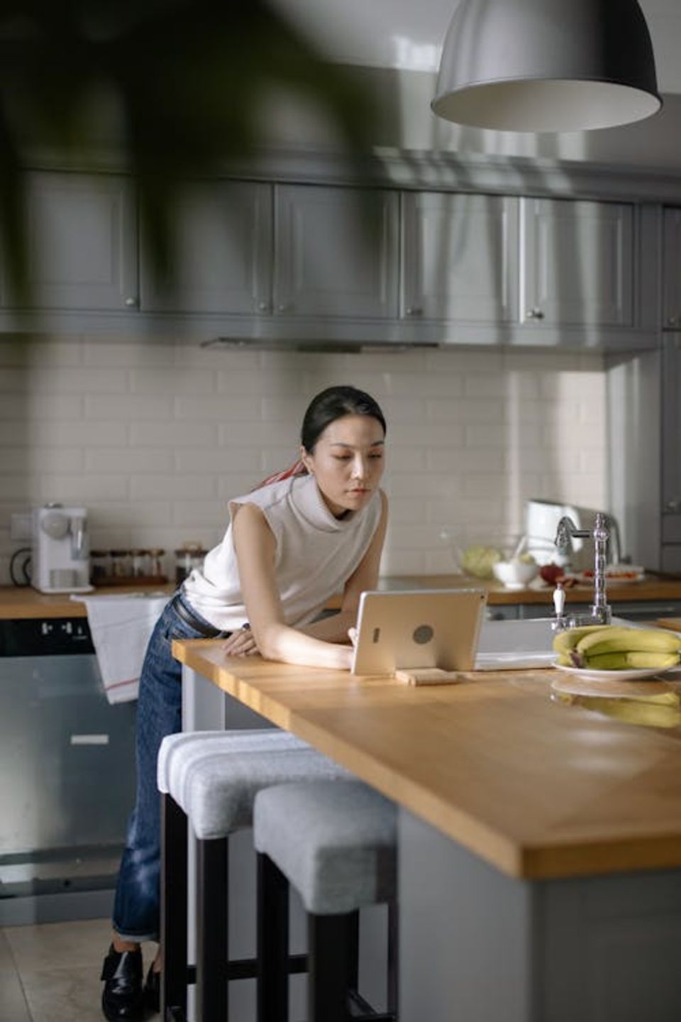 Homeowner reviewing completed document checklist on a tablet at a kitchen table