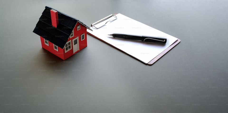 Home selling preparation checklist with pen and paperwork