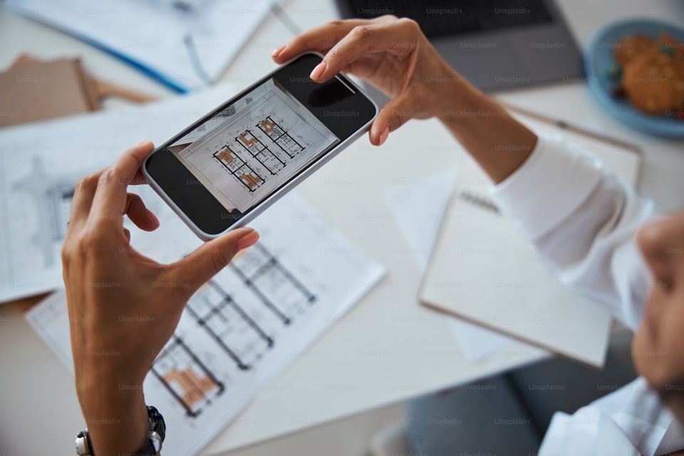 Homeowner using phone to photograph a service receipt for their home maintenance history report