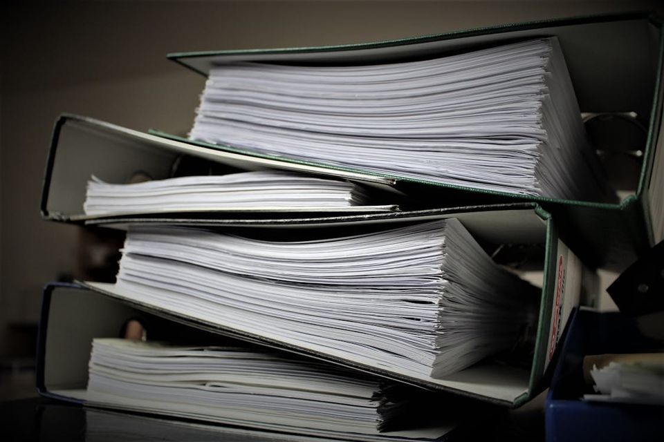 Side-by-side comparison of a cluttered filing cabinet versus a clean digital document dashboard