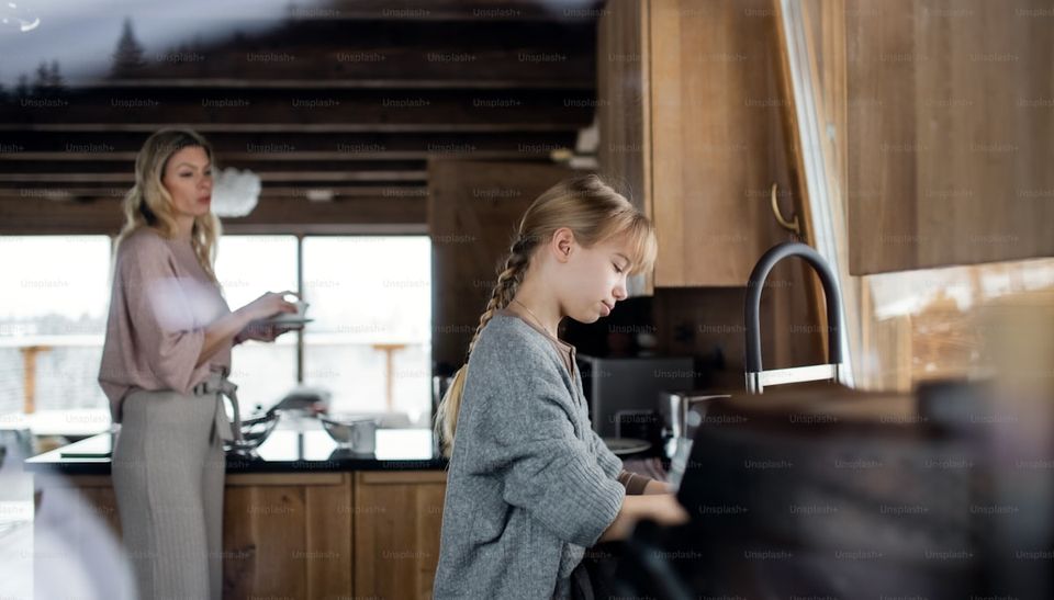 Homeowner organizing warranty documents for appliances and home systems at kitchen counter