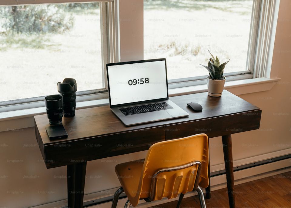 Homeowner at desk reviewing warranty documents and checking expiration dates on laptop