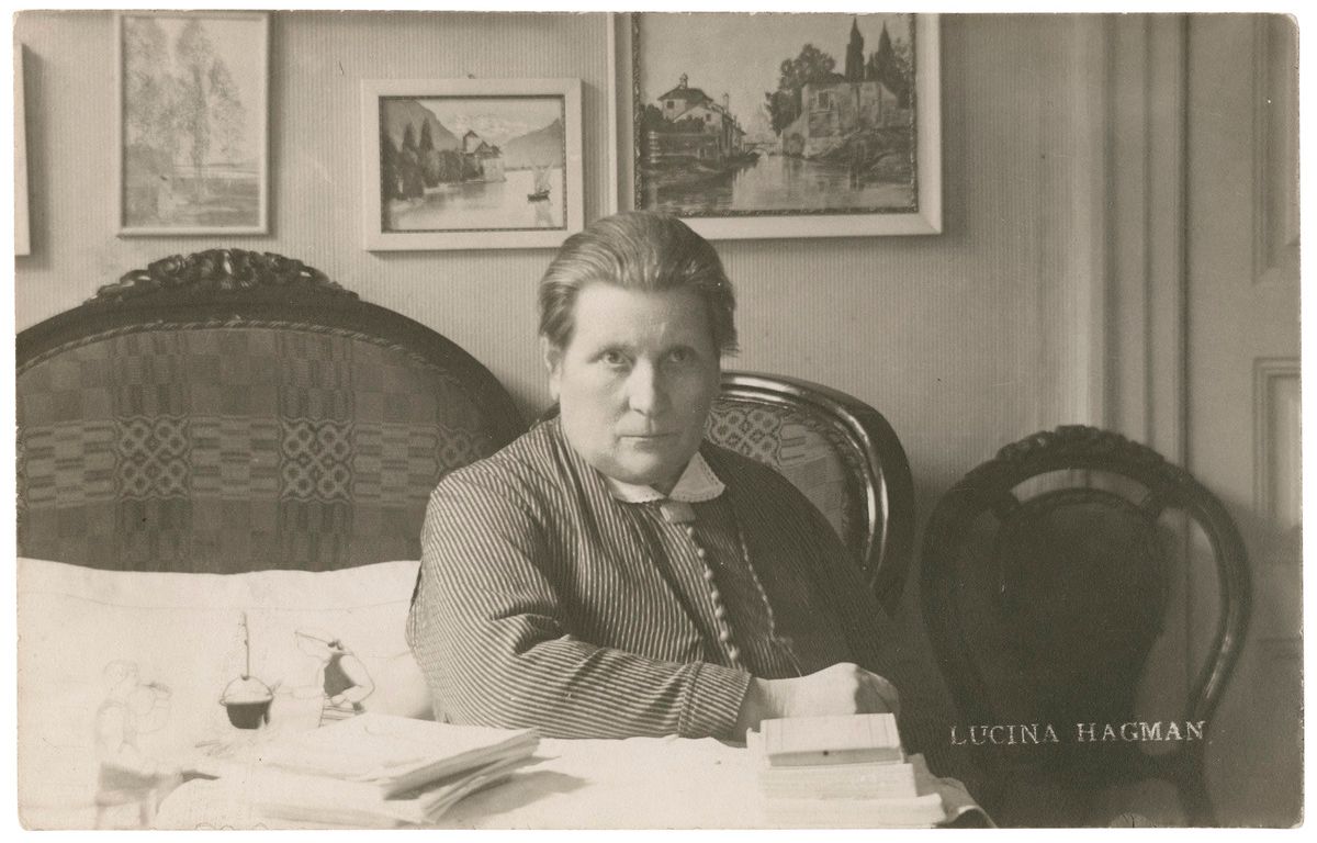 Лусина Хагман сидя за столом (Lucina Hagman istumassa pöydän ääressä)