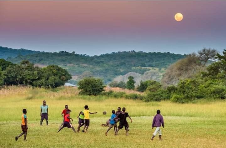 Young African players playing football, illustrating school football champions in Kenya