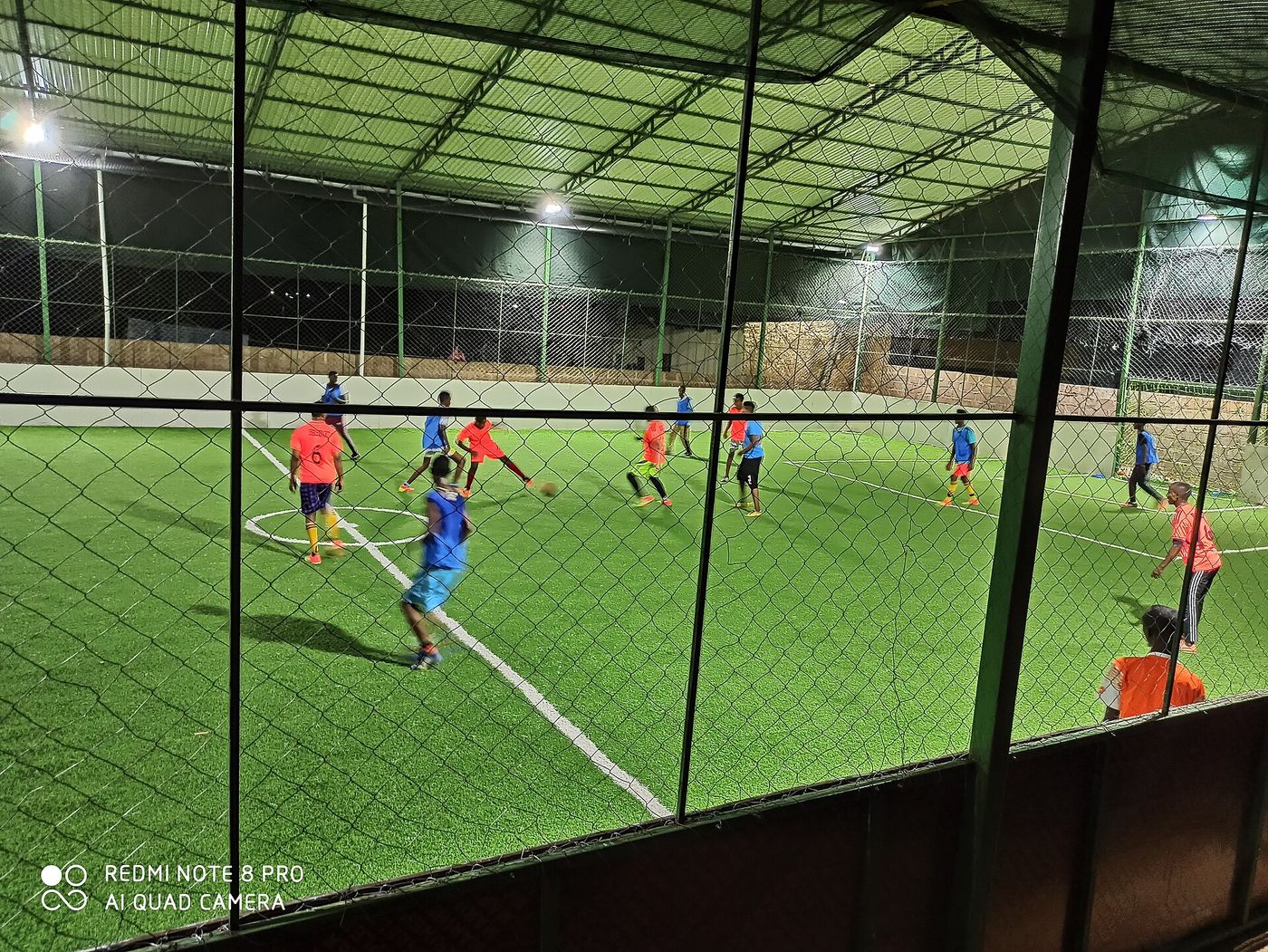Young players in a seven-a-side grassroots football game in Kenya