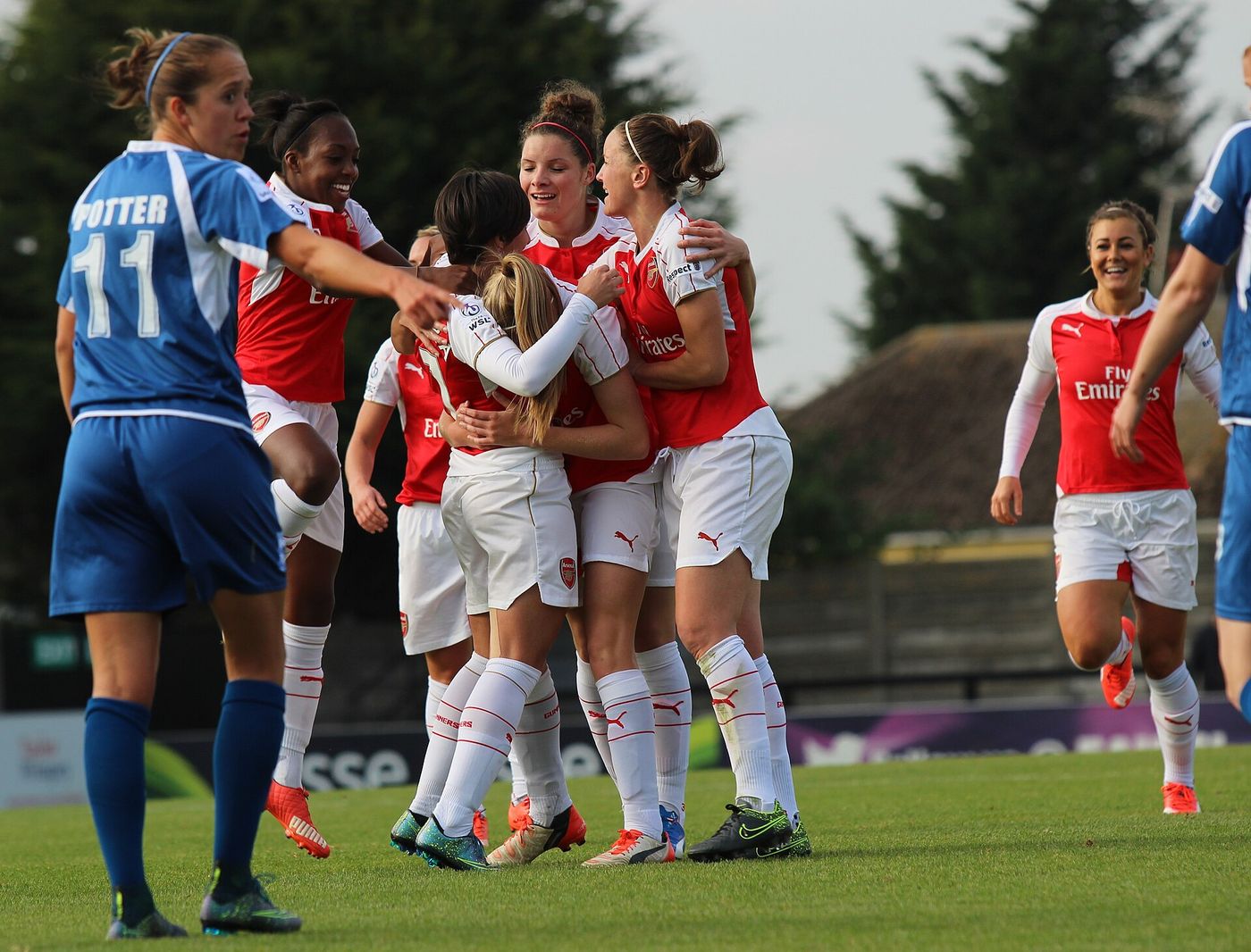 Women's football players celebrating a goal, as Kenya's Junior Starlets celebrate reaching the U-17 Women's World Cup last 16