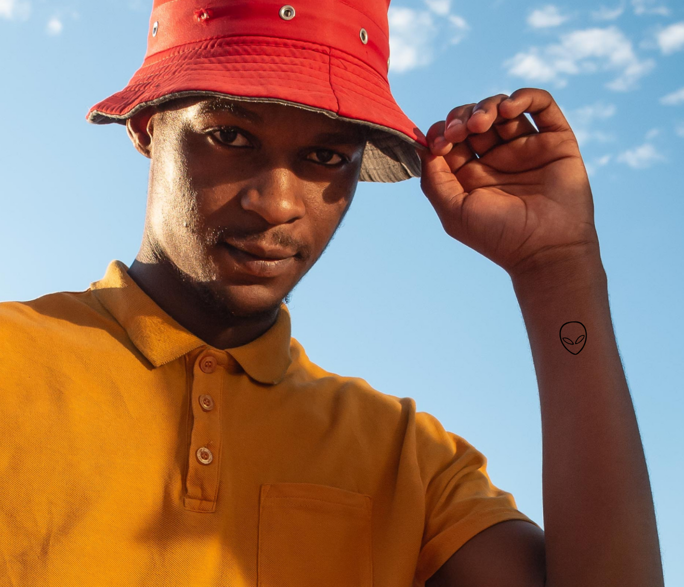 alien tattoo on wrist
