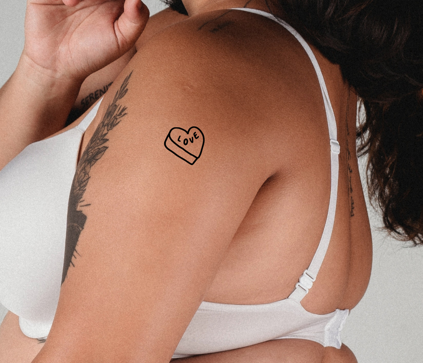 candy heart tattoo on arm