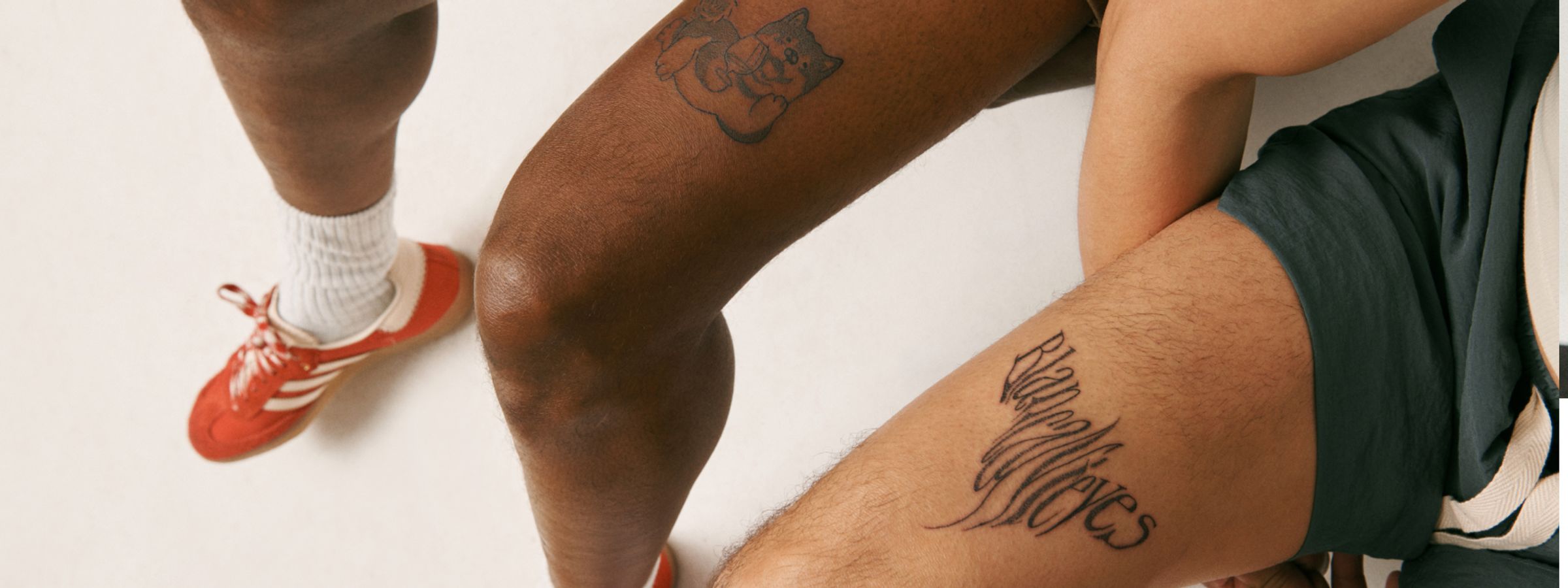 two legs with text tattoo and dog tattoo text