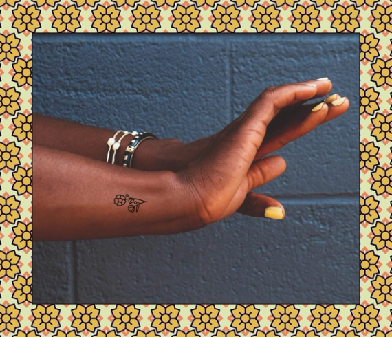 tiny flower tattoo on wrist
